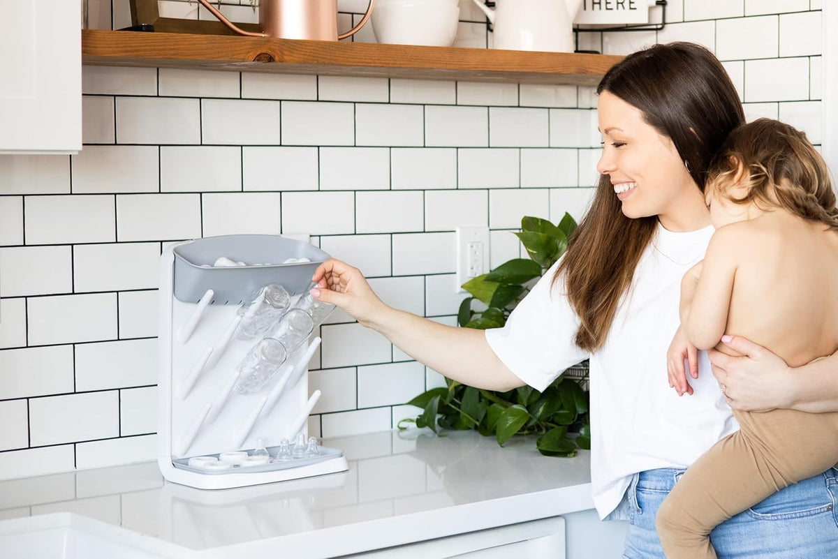 Ubbi Vertical Baby Bottle Drying Rack, Space Saving Countertop Bottle Dryer | 13-Peg Bottle Drying Rack Removable Drain Tray, Baby Organizer for Pump Parts, Pacifiers & Accessories, Dishwasher Safe, Gray